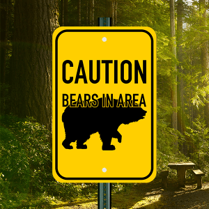 Yellow Sign w/ Black Text & Image of Bear