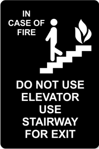 Black Sign w/ White Text - "In Case of Fire - Do Not Use Elevator"