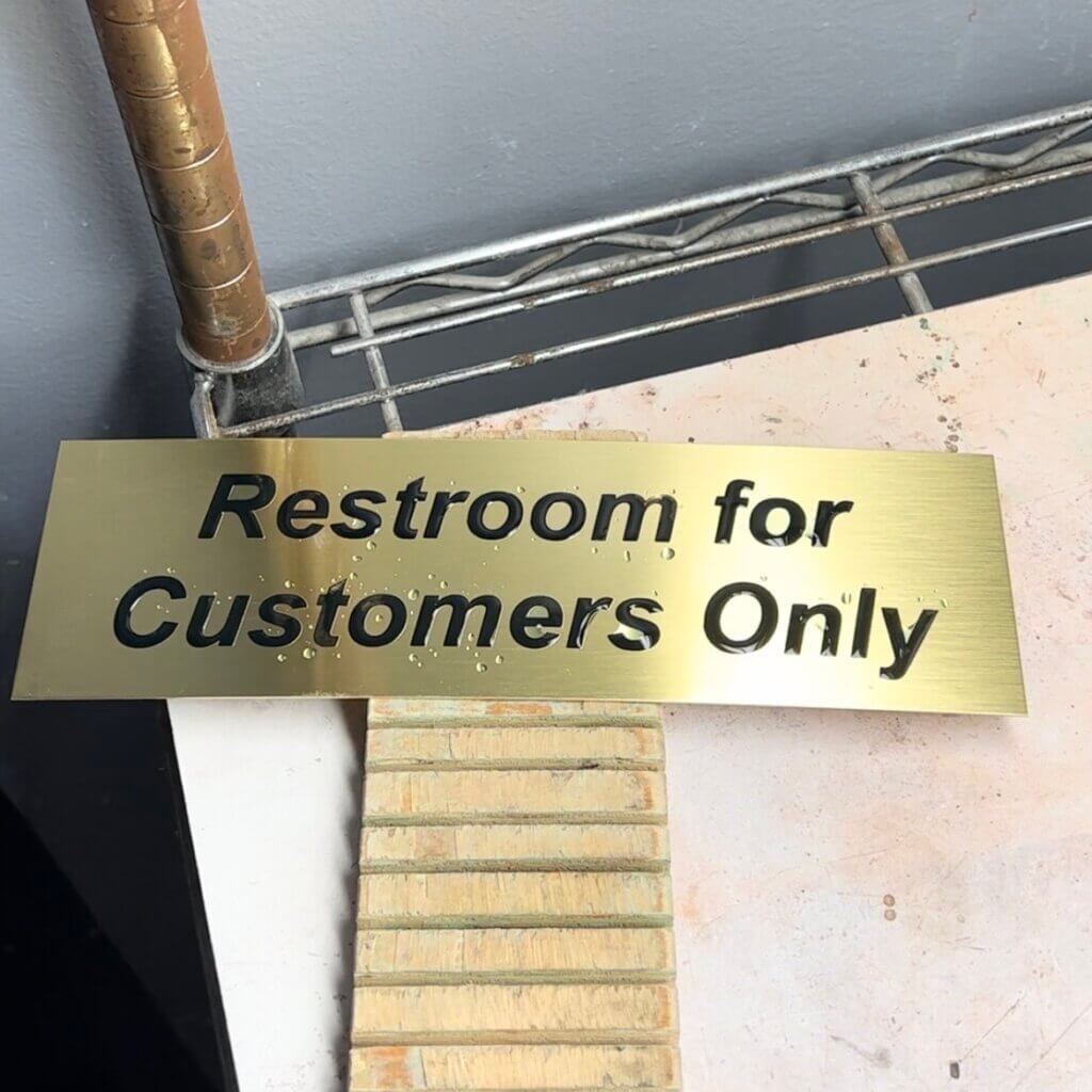 The Engraved Brass Plate With Its Letters Completely Oxidized