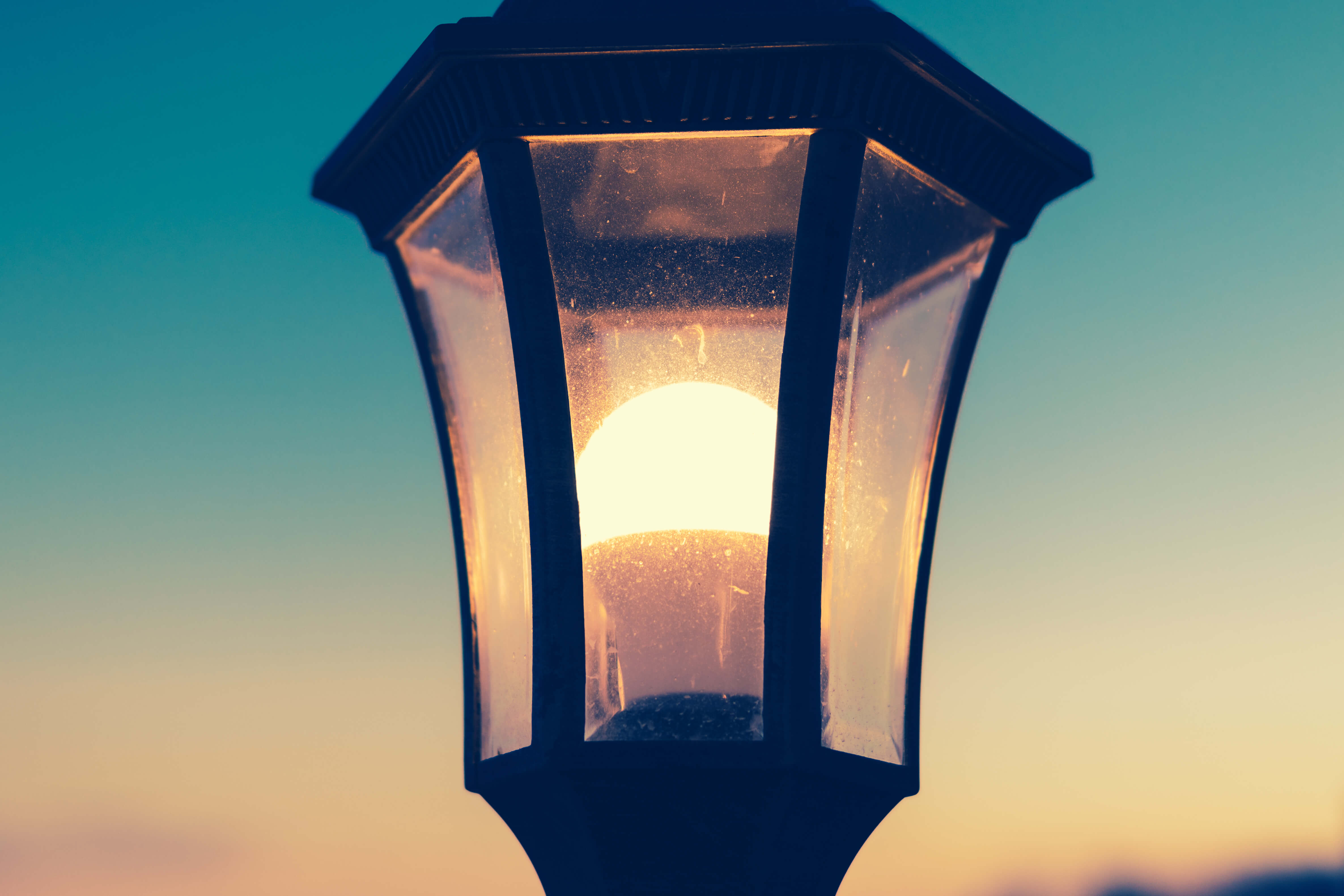 Close-up of a street lamp glowing in retro colors