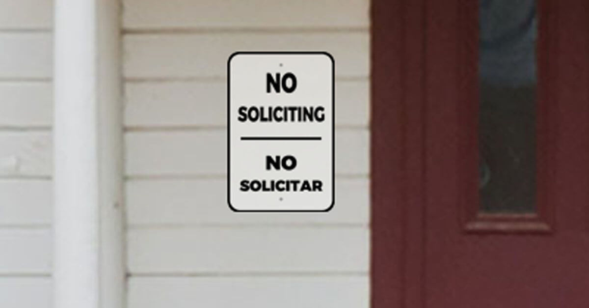 Bilingual No Soliciting Sign Near Front Door